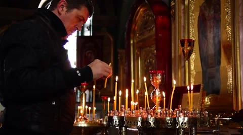 The man lights, light candles and baptized in the Church. Stock Footage 49408090