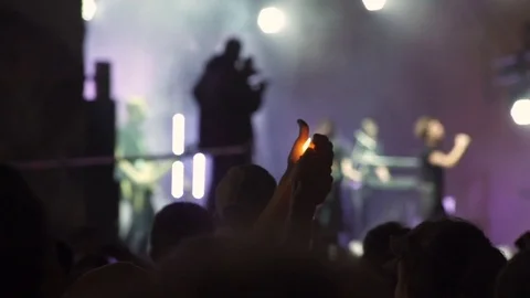 Man lights the lighter with a blurred scene in front of him Stock Footage