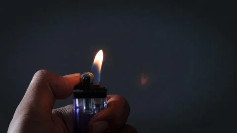 A man lights a lighter Stock Footage 335679712