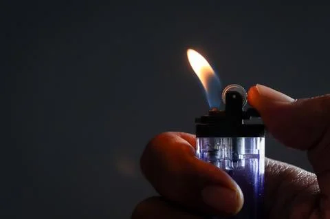 A man lights a lighter Stock Photos