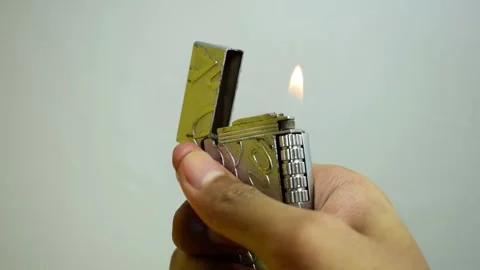 A man lights a match, metalic silver lighter Stock Footage 252018864