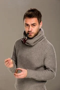 Man lights a pipe Stock Photos