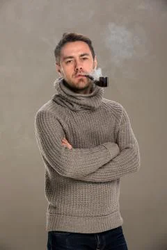 Man lights a pipe Stock Photos
