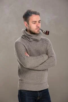 Man lights a pipe Stock Photos