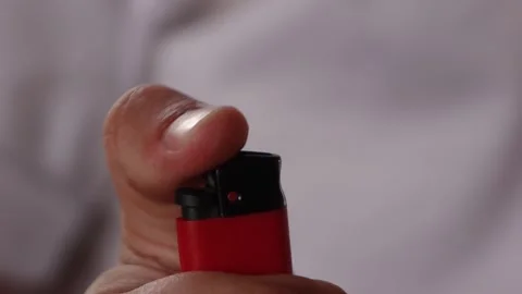A man lights a red lighter close up Vídeo Stock 133346418