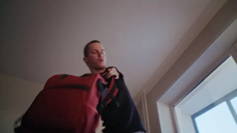 Man with Limb Difference Putting on Backpack at Home Vidéo 321938930