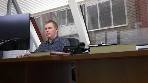 The man listened to comments on the work on the phone and continued to work Stock Footage 111519801