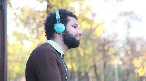 Man listening to music with headphones, enjoying in nature Stock Footage 59556022