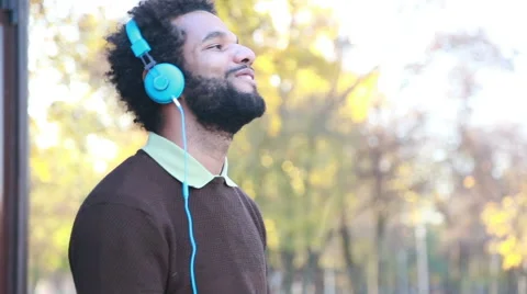 Man listening to music with headphones Stock Footage 59556026