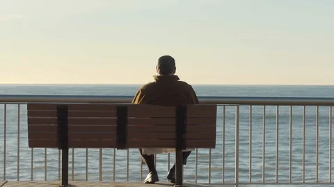 Man listening to music while starring at the ocean Stock Footage 88287977