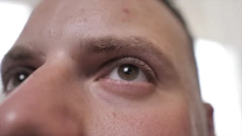 A man listens to something frame on his nose and eyes Stock Footage 239362948