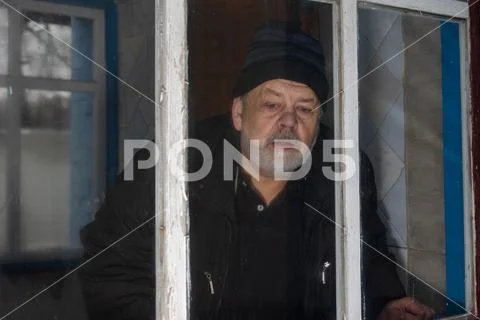 Photograph: Man living alone in rural Ukrainian village peeping out ...