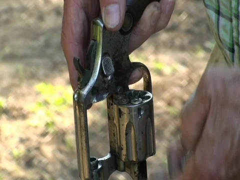 Man loading 6-shooter.  Stock Footage 79296004