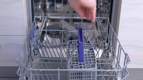 Man loading and unloading dishwasher white dishes, cutlery, high speed video. Stock Footage 116376022