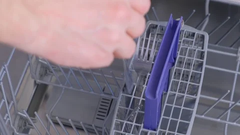 Man loading and unloading dishwasher white utensil, cutlery, high speed video. Stock Footage 116857449