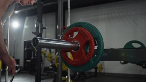Man Loading Barbell with Weight Plates for Strength Training Stock-Footage 339881269