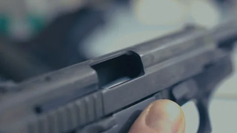 Man loading bullets into gun, close-up of hands CSI Stock Footage 86445324