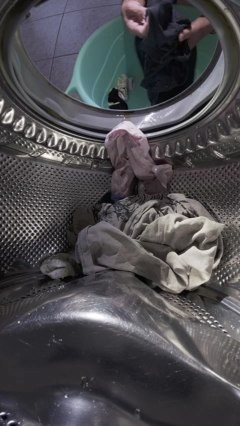Man Loading Clothes into Washing Machine, Inside Drum View Video stock 332908938