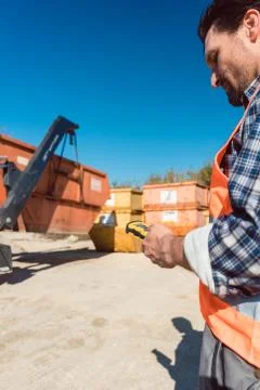 Man loading of construction debris container on truck 스톡 사진