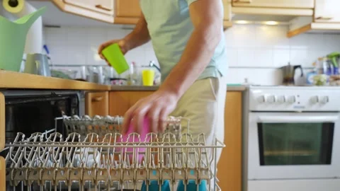 A man loading a dishwasher Stock Footage 302190606