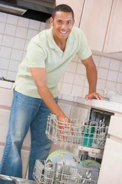 Man loading dishwasher Stock Photos