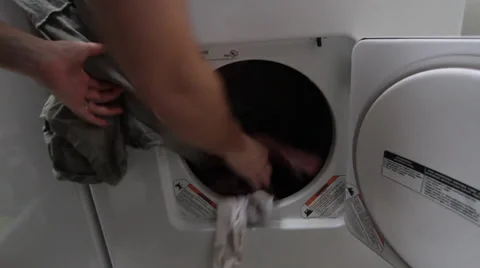 Man Loading Dryer Stock Footage 34480699