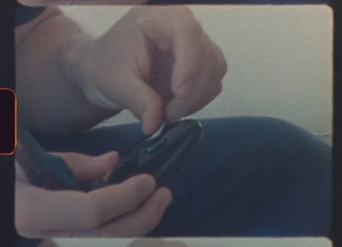 Man loading film roll into compact camera with retro super 8 look Video stock 319829462