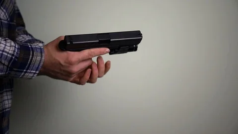 Man loading a handgun. concealed carry and gun control Stock Footage 98802959