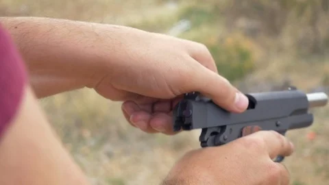 Man Loading a Handgun in Slow Motion Video stock 88374378