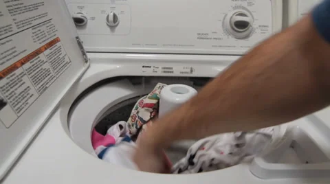 Man Loading Laundry into Machine Video stock 34481138