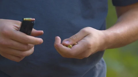 Man Loading a Pistol Clip with 9mm Rounds Stock Footage 97926135