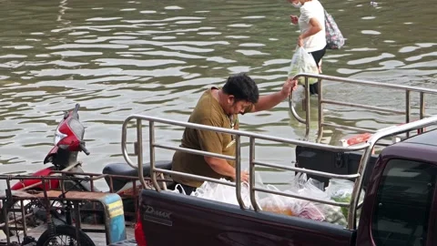 A man loading a purchase from a flooded market Stock Footage 240003866