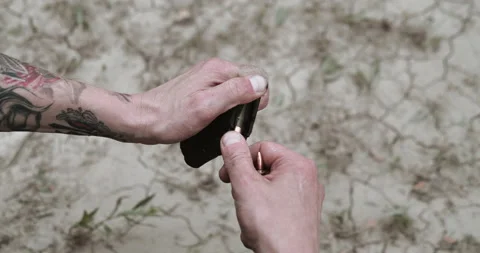 Man loading rifle cartridges into polymer magazine Stock Footage 134391668