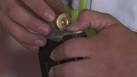 Man loading shotgun shells into a magazine Stock Footage 138905744