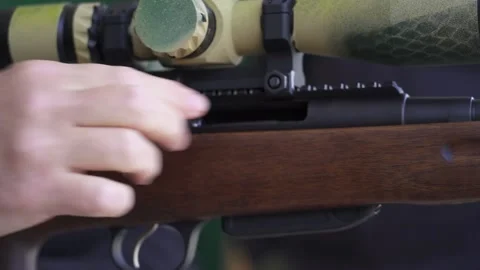 Man loading a sniper rifle for target practice. Close-up Stock Footage 238744444