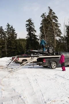 Man loading snowmobile on van Stock Photos