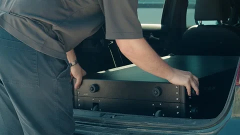 Man Loading Utility Cart into Vehicle for Transport Stock Footage 341995524