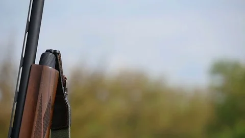 Man loads a breechlock chamber and starts shooting in a fileld in slo-mo Vídeo Stock 76053921