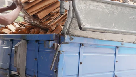 Man loads cardboard boxes scraps into the truck to recycling factory. Stock-Footage 225427879