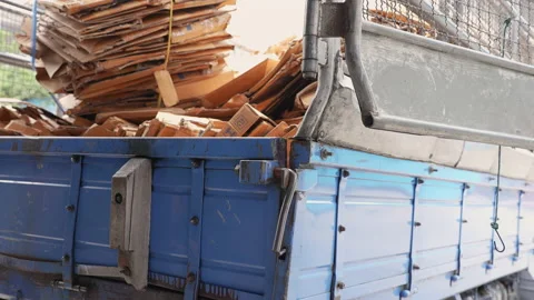 Man loads cardboard boxes scraps into the truck to recycling factory. Stock Footage 225428284