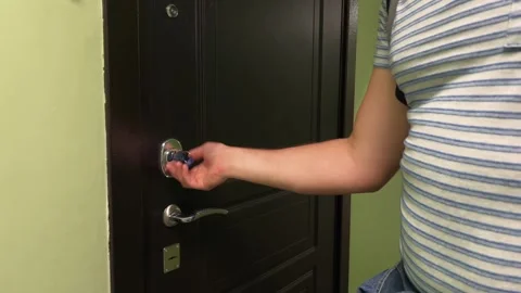 Man locking apartment door turning key in door lock leaving for work Video stock 266783476