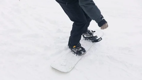 Man Locking Boots in Snowboard for Skiing 動画素材 103757741