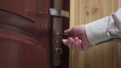 Man locking front door Stock Footage 310539246