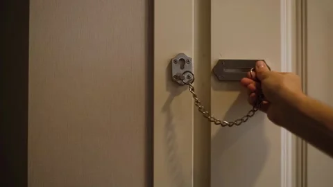 A man locks the door with a chain Stock Footage 260691826