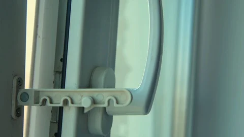 Man locks the window in tilt and turn position Stock Footage 129610295