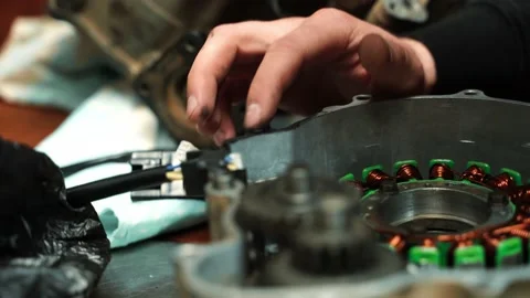 A man locksmith puts sealant on an ATV engine Vidéo 160490870