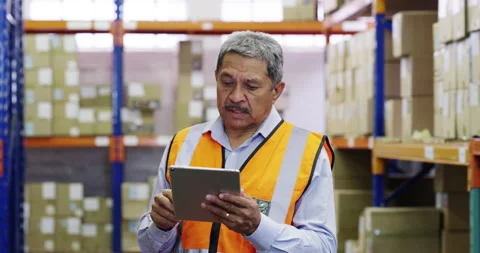 Man, logistics and tablet in warehouse with counting for stocktaking, boxes and Stock Footage 345803795