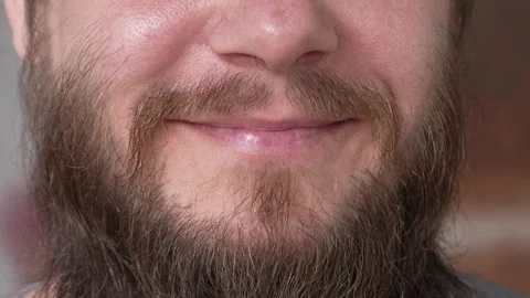 A man with a long beard smiles uncertainly Stock-Footage 282520029