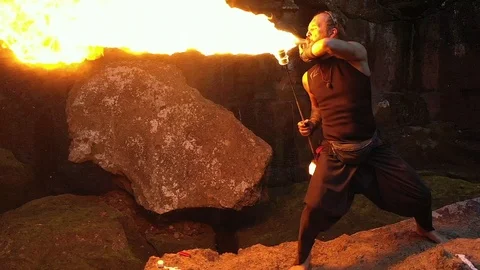 A man with a long beard spits out fire from his mouth. Video stock 113322006