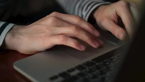 A man with long, dirty fingernails uses the touchpad of a laptop. Serene Stock Footage 264060504